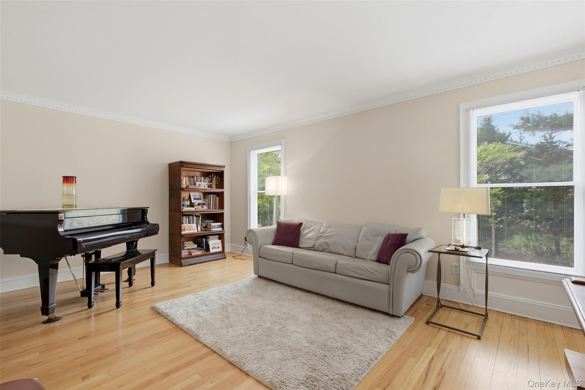 7 Gun Path Setauket, NY 11733 - Photo 8 of 34 a living room with furniture a wooden floor and a large window