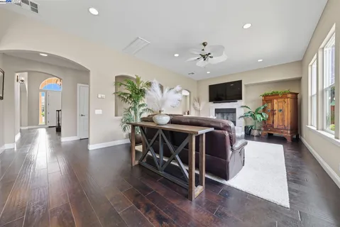 a dinning room with furniture a window and wooden floor