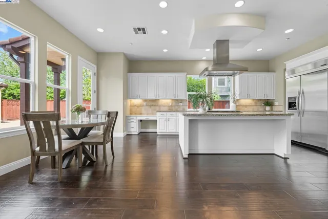 a kitchen with counter top space a sink appliances and cabinets