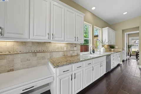 a large kitchen with a table and chairs
