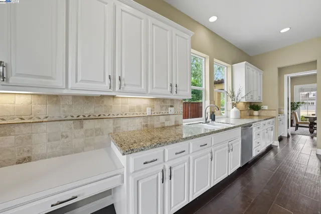 a large kitchen with a table and chairs