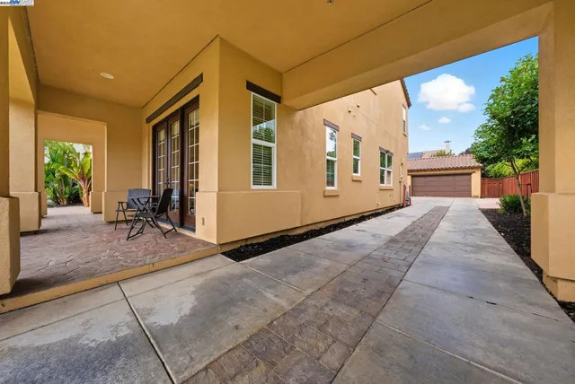 a view of a house with backyard and sitting area