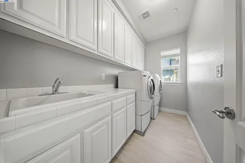 a view of a hallway with wooden floor and stairs