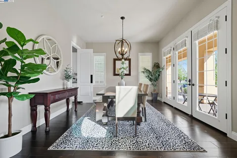 a living room with furniture a chandelier a rug and a window