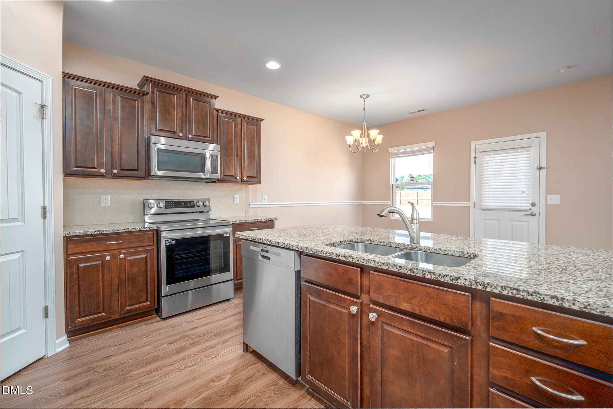 3548 Althorp Drive Raleigh, NC 27616 - Photo 13 of 56 a kitchen with stainless steel appliances granite countertop a sink stove and refrigerator