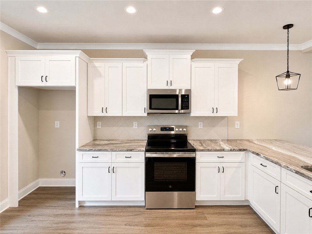 328 Point Road Westminster, SC 29693 - Photo 3 of 24 Culinary dreams come alive in this pristine kitchen, featuring elegant counters and modern appliances.