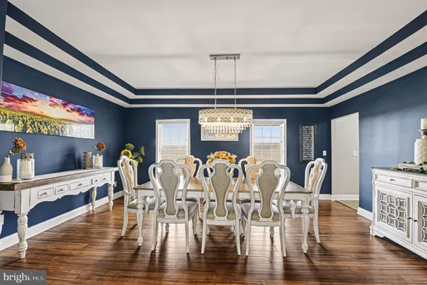 a view of a dining room with furniture wooden floor and chandelier