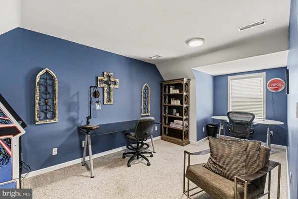a view of a livingroom with workspace and a couch