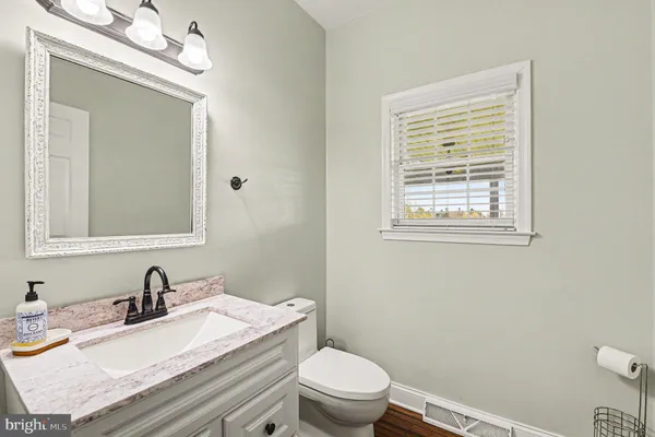 a white toilet sitting next to a bathroom sink