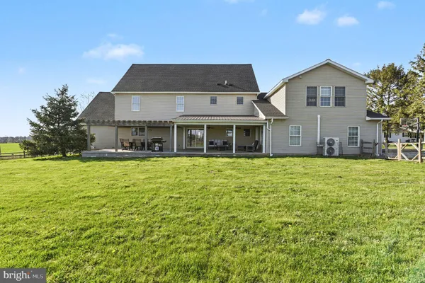 a front view of house with yard and lake