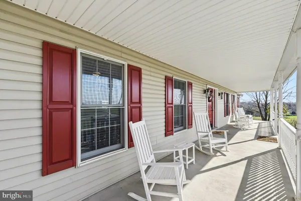 a view of a patio with couches table and chairs and wooden floor