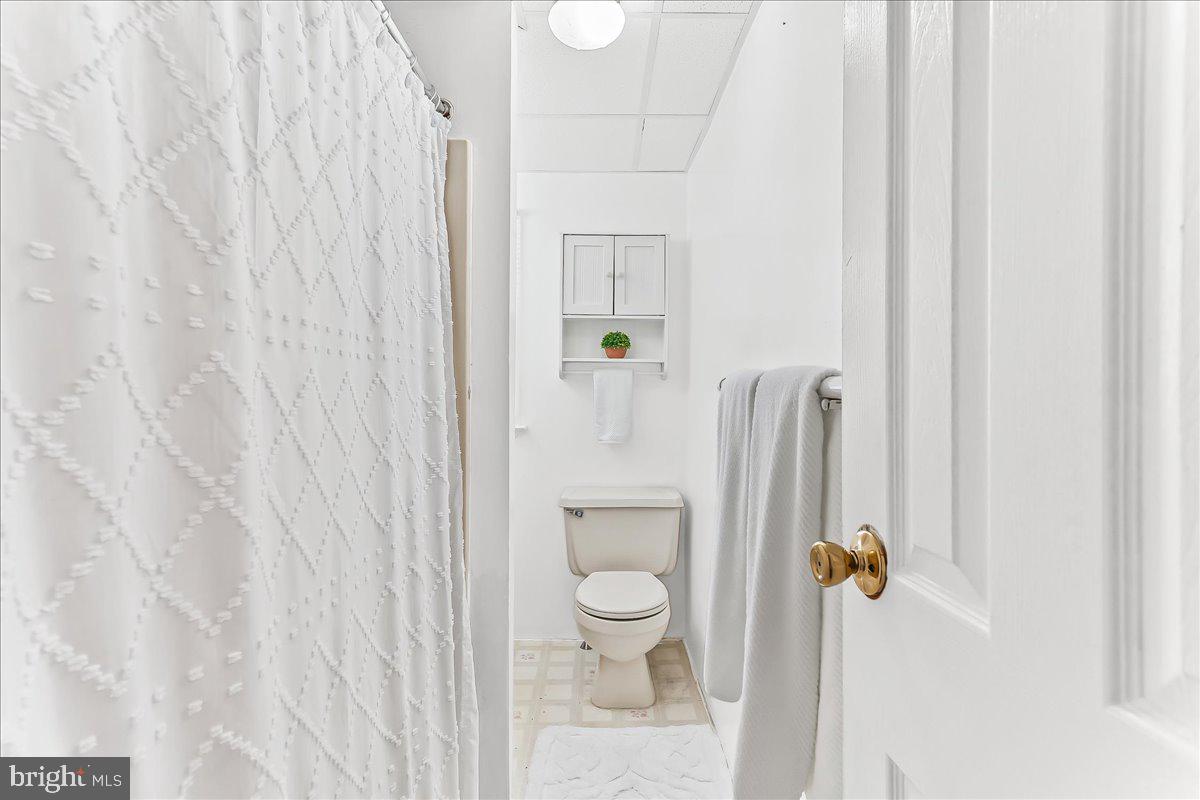 4518 Post Road Marcus Hook, PA 19061 - Photo 10 of 24 a bathroom with a shower curtain and toilet