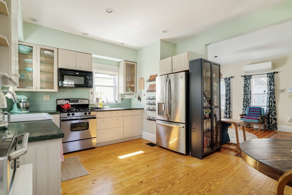 10 Gilman Street Boston, MA 02131 - Photo 12 of 41 a kitchen with granite countertop a refrigerator and a stove top oven