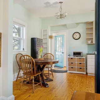 a view of a dining room with furniture window and wooden floor