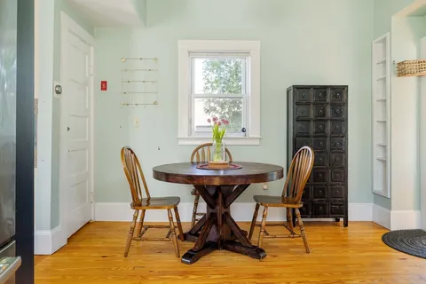 a view of a dining room with furniture and window