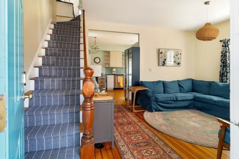 a living room with furniture and a lamp
