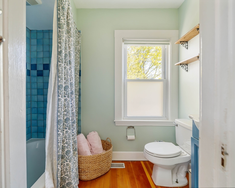 10 Gilman Street Boston, MA 02131 - Photo 22 of 41 a bathroom with a toilet sink and window