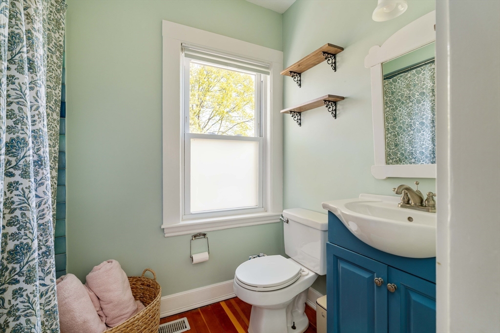 10 Gilman Street Boston, MA 02131 - Photo 23 of 41 a bathroom with a sink toilet and a mirror