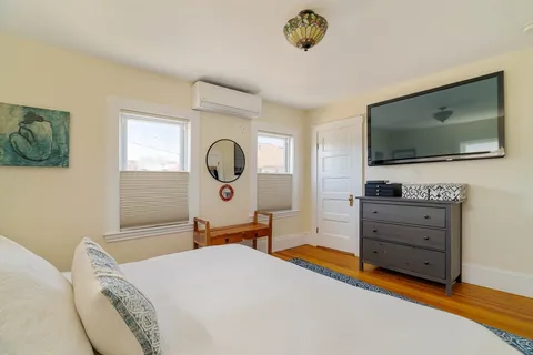a bed room with a bed and a television