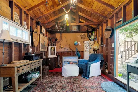 a room with lots of wooden furniture and a rug