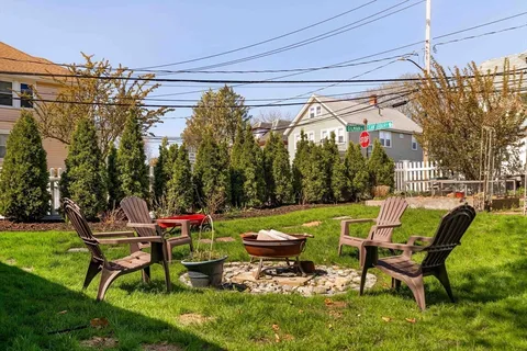 a swimming pool with outdoor seating and yard
