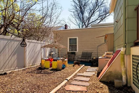 a backyard of a house with barbeque oven