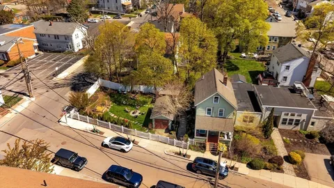 an aerial view of multiple houses with yard