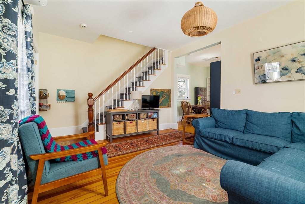 10 Gilman Street Boston, MA 02131 - Photo 5 of 41 a living room with furniture stairs and a potted plant