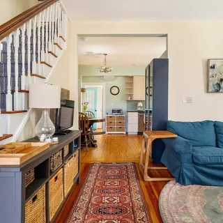 a living room with furniture and wooden floor