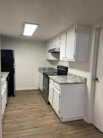 a kitchen with granite countertop wooden cabinets and a stainless steel appliances