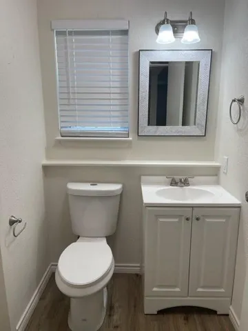 a bathroom with a toilet sink and mirror
