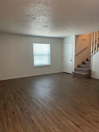 a view of wooden floor and windows in a room