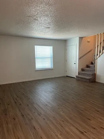 a view of wooden floor and windows in a room