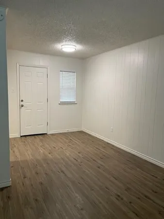 a view of an empty room and wooden floor