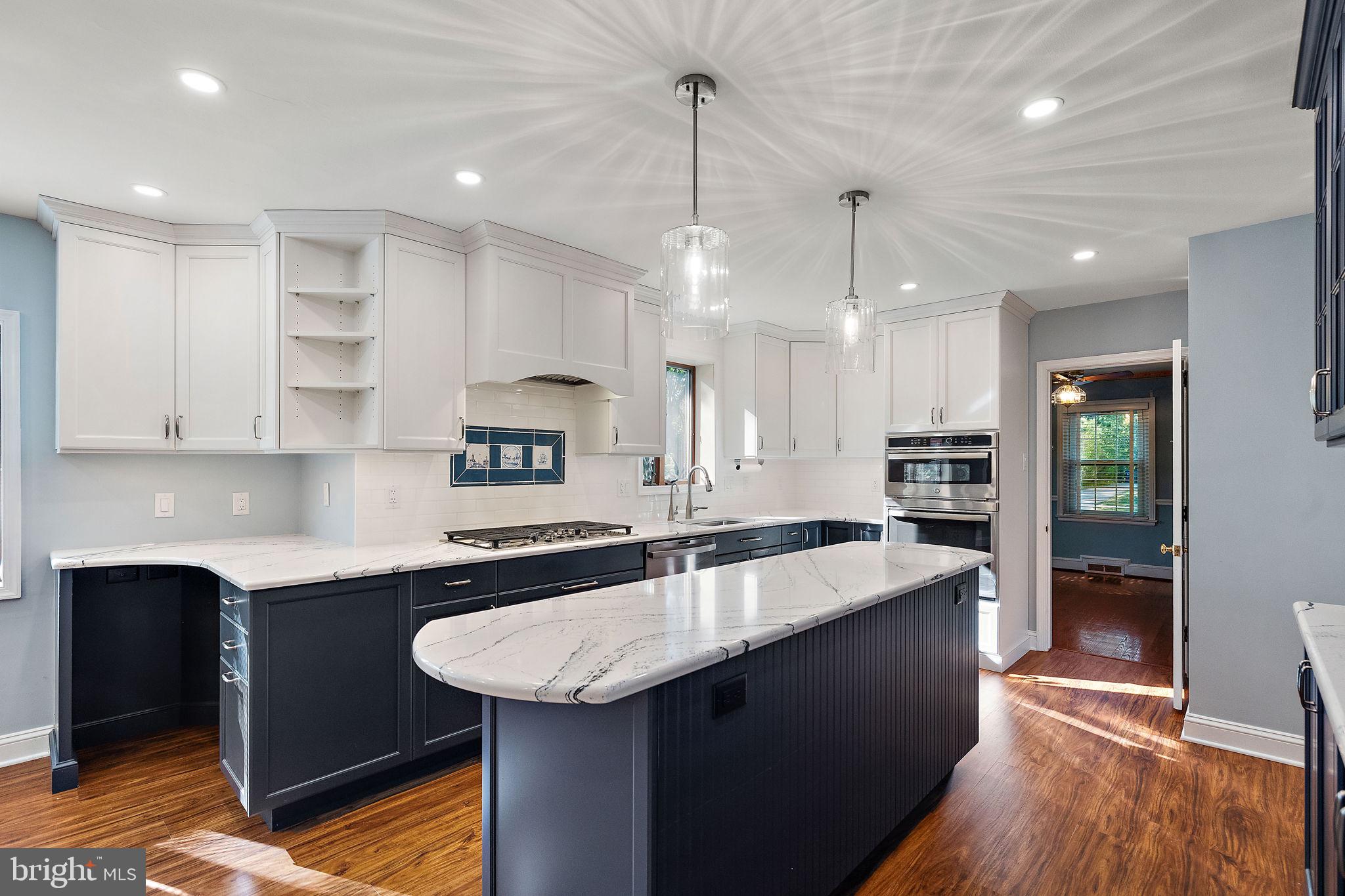 9 Granite Road Wilmington, DE 19803 - Photo 12 of 55 a kitchen with kitchen island a sink stainless steel appliances and cabinets