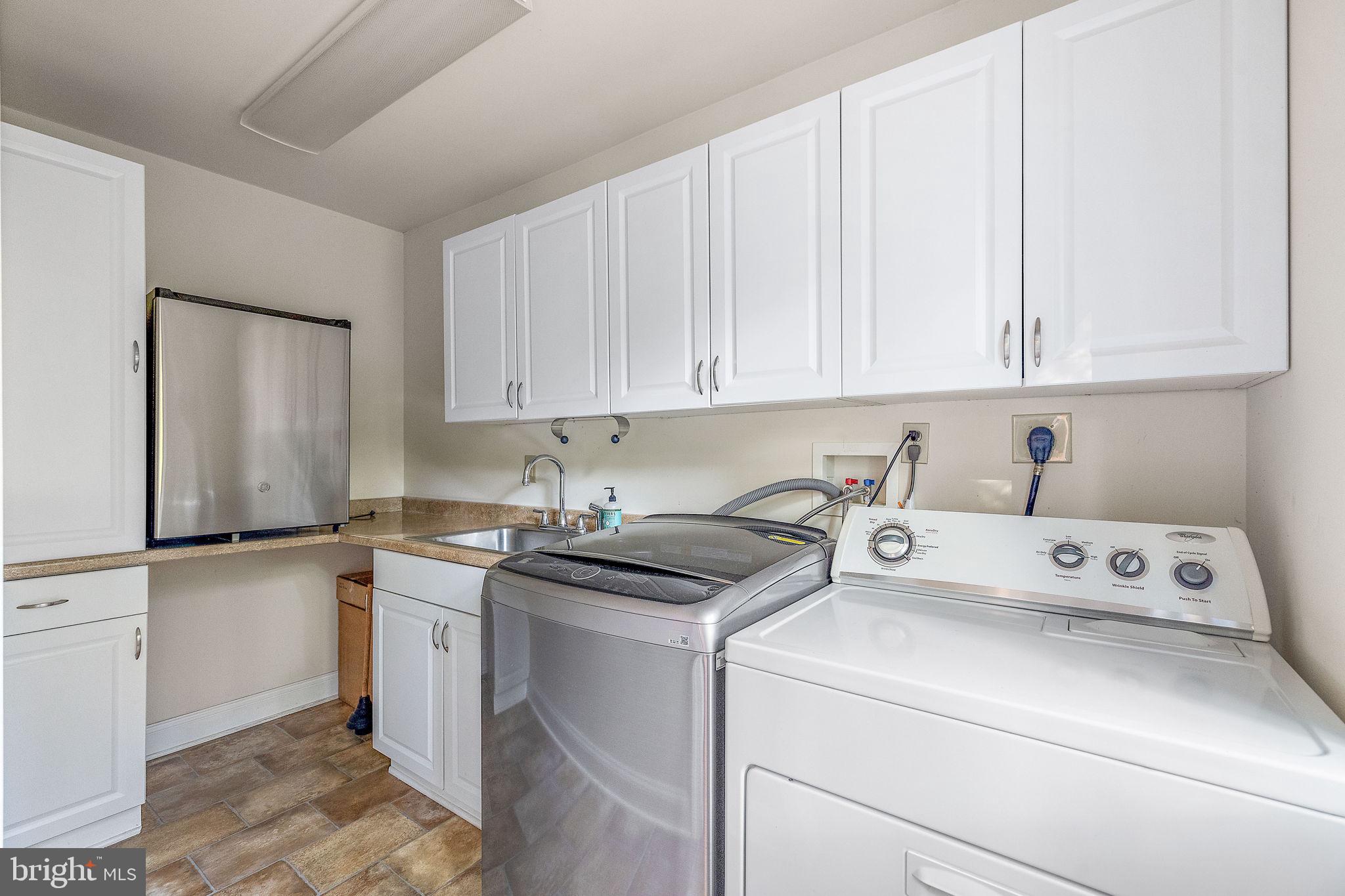 9 Granite Road Wilmington, DE 19803 - Photo 22 of 55 a view of cabinets a washer and dryer