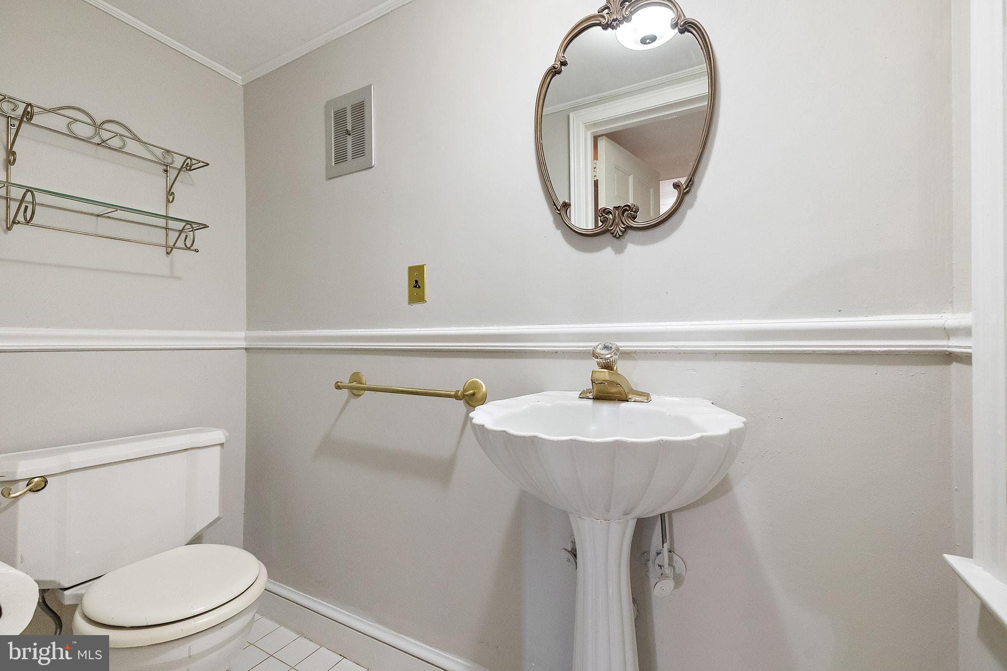9 Granite Road Wilmington, DE 19803 - Photo 23 of 55 a bathroom with a sink a mirror and a toilet