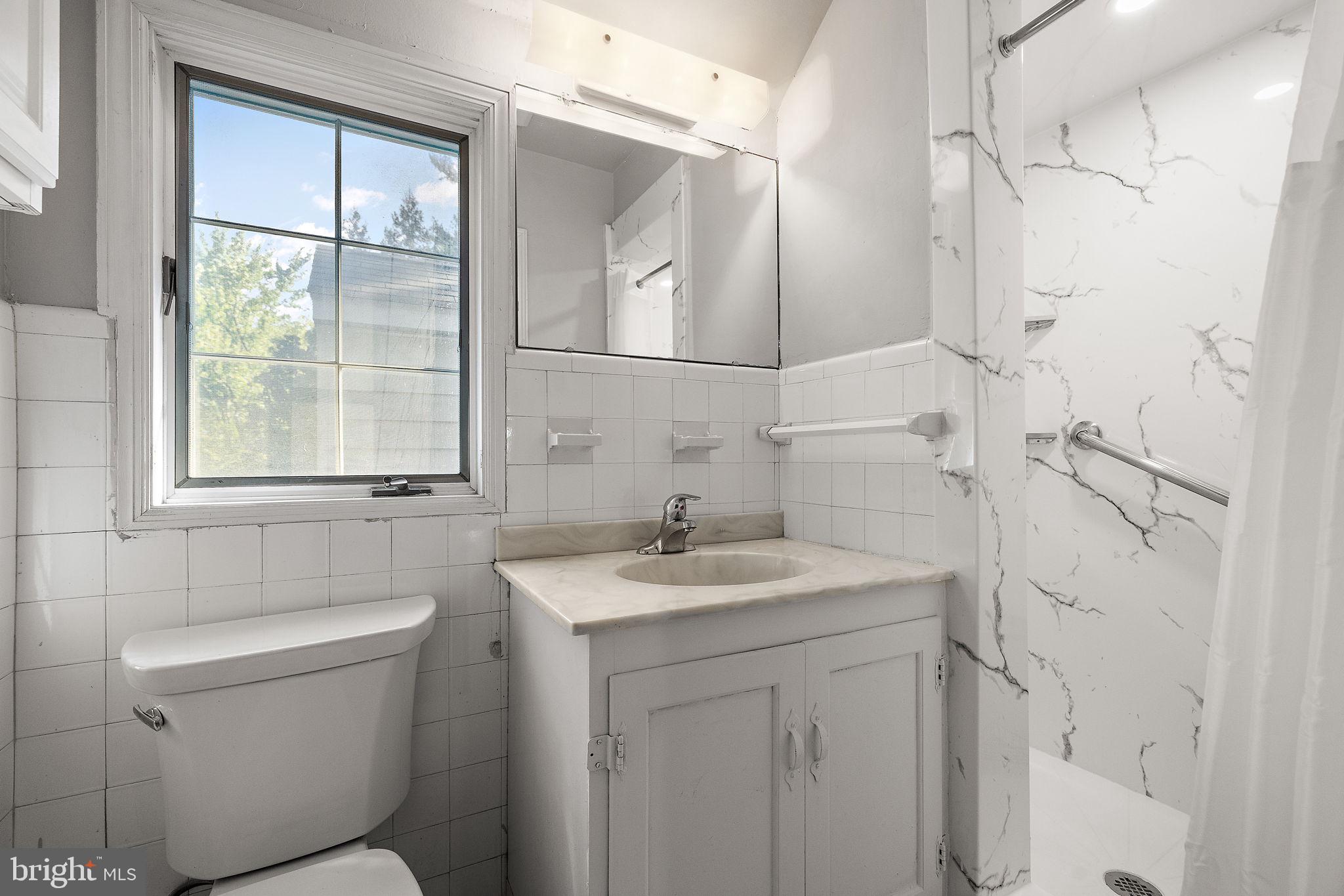 9 Granite Road Wilmington, DE 19803 - Photo 28 of 55 a bathroom with a sink toilet vanity and shower