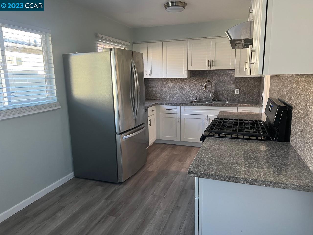 3620 Chestnut Street Lafayette, CA 94549 - Photo 7 of 19 a kitchen with granite countertop a refrigerator and a stove top oven