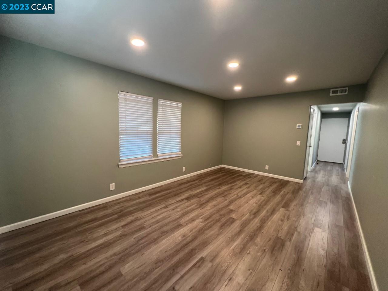 3620 Chestnut Street Lafayette, CA 94549 - Photo 10 of 19 an empty room with wooden floor and windows