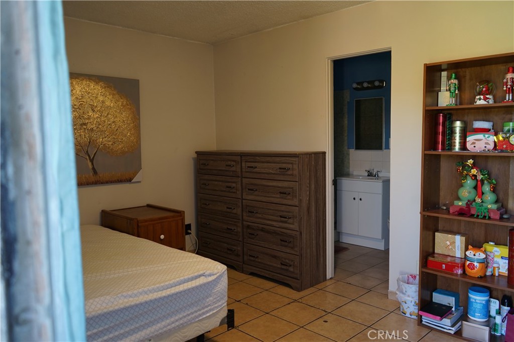 14510 Amar Road, Unit J La Puente, CA 91744 - Photo 2 of 7 a bedroom with a bed and a closet