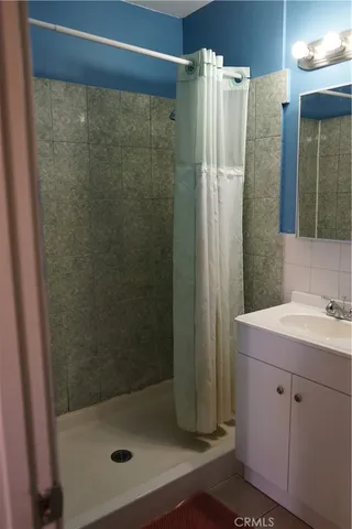 a bathroom with a shower and a sink