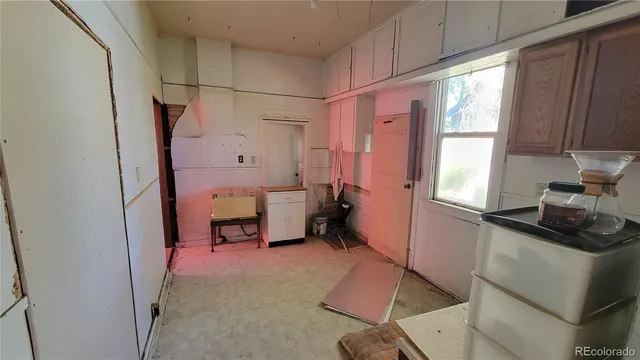 a kitchen that has a sink and a refrigerator