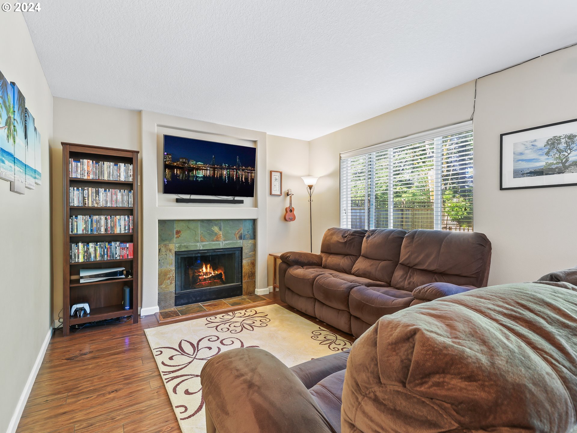 4888 Southeast Antelope Hills Gresham, OR 97080 - Photo 19 of 45 a living room with furniture a fireplace and a flat screen tv