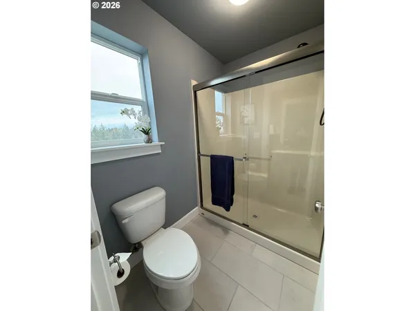 a bathroom with a toilet and a shower