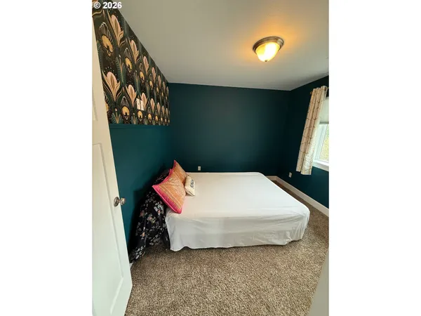 a utility room with a bed and a window