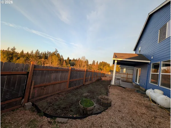 a view of a backyard with plants and a patio