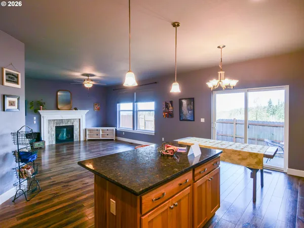 a kitchen with sink dining table and chairs