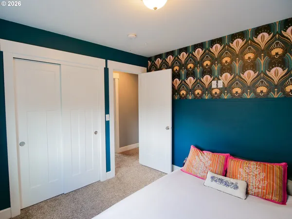 a bedroom with a bed and a wall painting