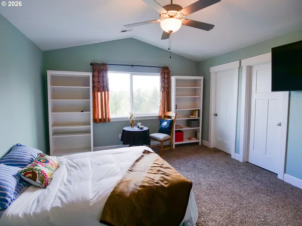 a bed room with a bed and a chair